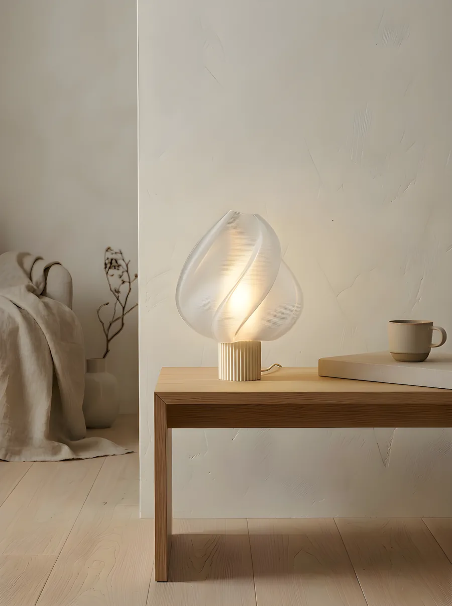 Elysian Table Lamp — ribbed 3D-printed table lamp in soft paper tone resting on a wooden bench